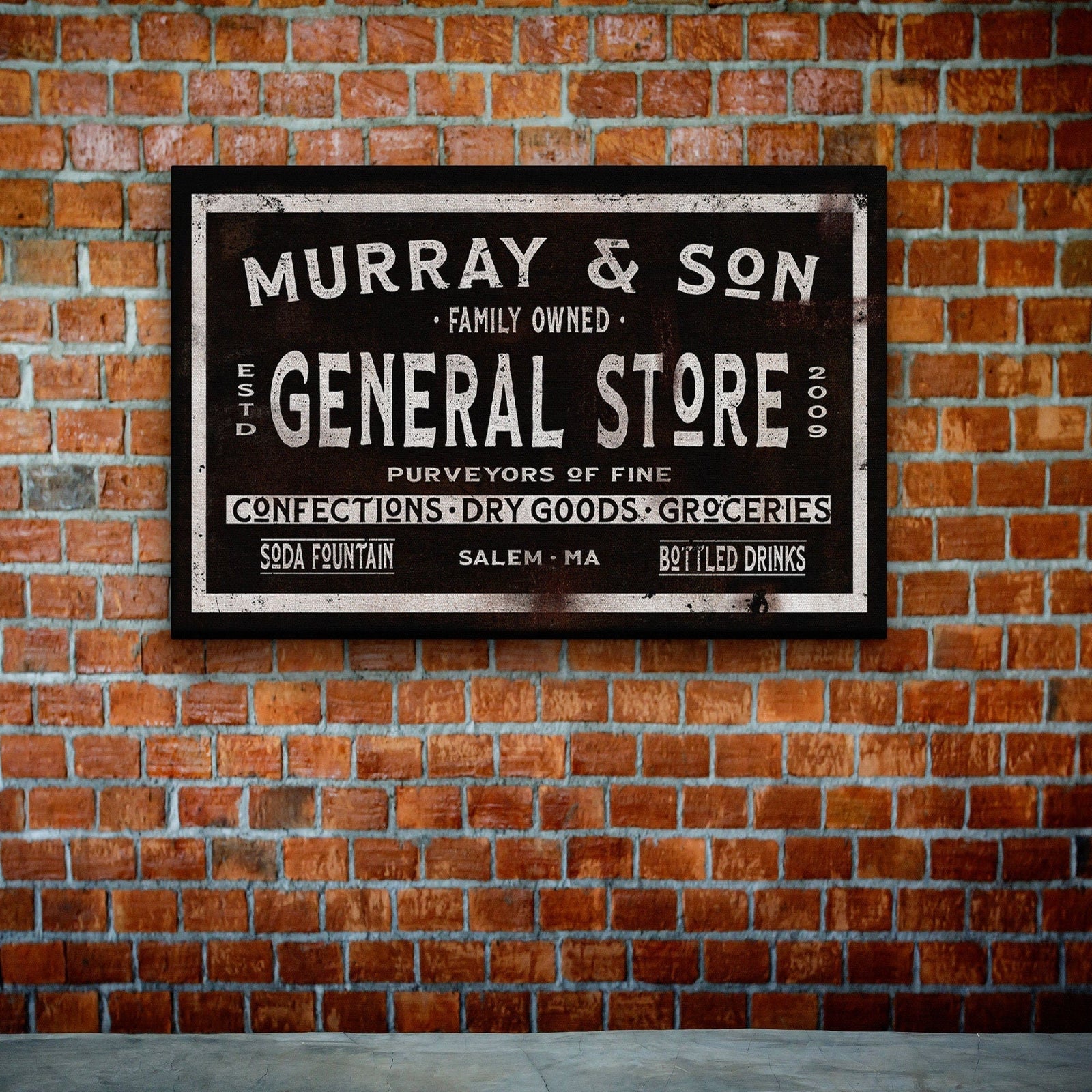 Vintage-style general store sign mounted on red brick wall, displaying "Murray & Son" with "Family Owned" and "General Store Est 2009" in distressed cream lettering on black background.