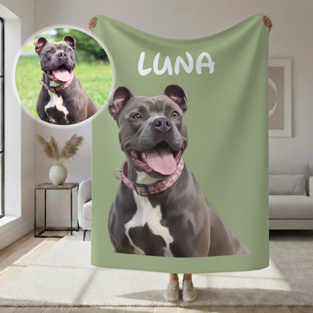 Sage green sherpa blanket printed with cartoon dog portrait labeled "LUNA" and circular photo inset of a smiling dog in outdoor setting, displayed held up indoors.