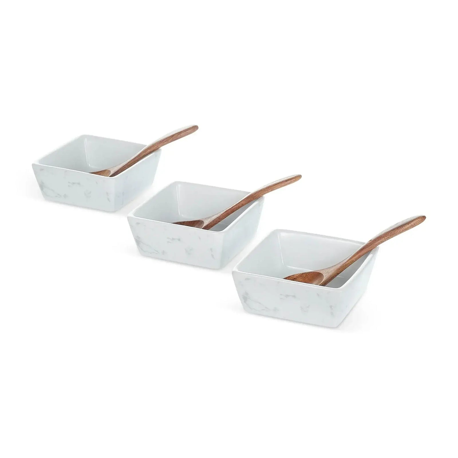 Three white marble square bowls with wooden serving spoons arranged in a row