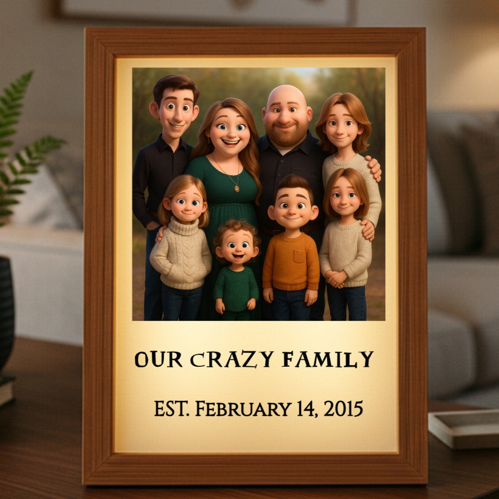 Wooden-framed light box displaying animated family portrait with sample text "Our Crazy Family" and "Est. February 14, 2015" on cream background below illustration