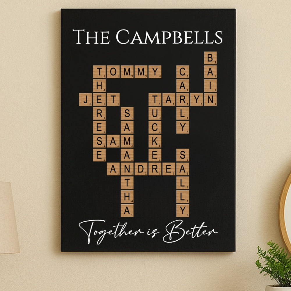 Black wall art displaying family names in crossword puzzle format with sample names including Tommy, Jet, Taryn, and Andrea, with "Together is Better" text at bottom