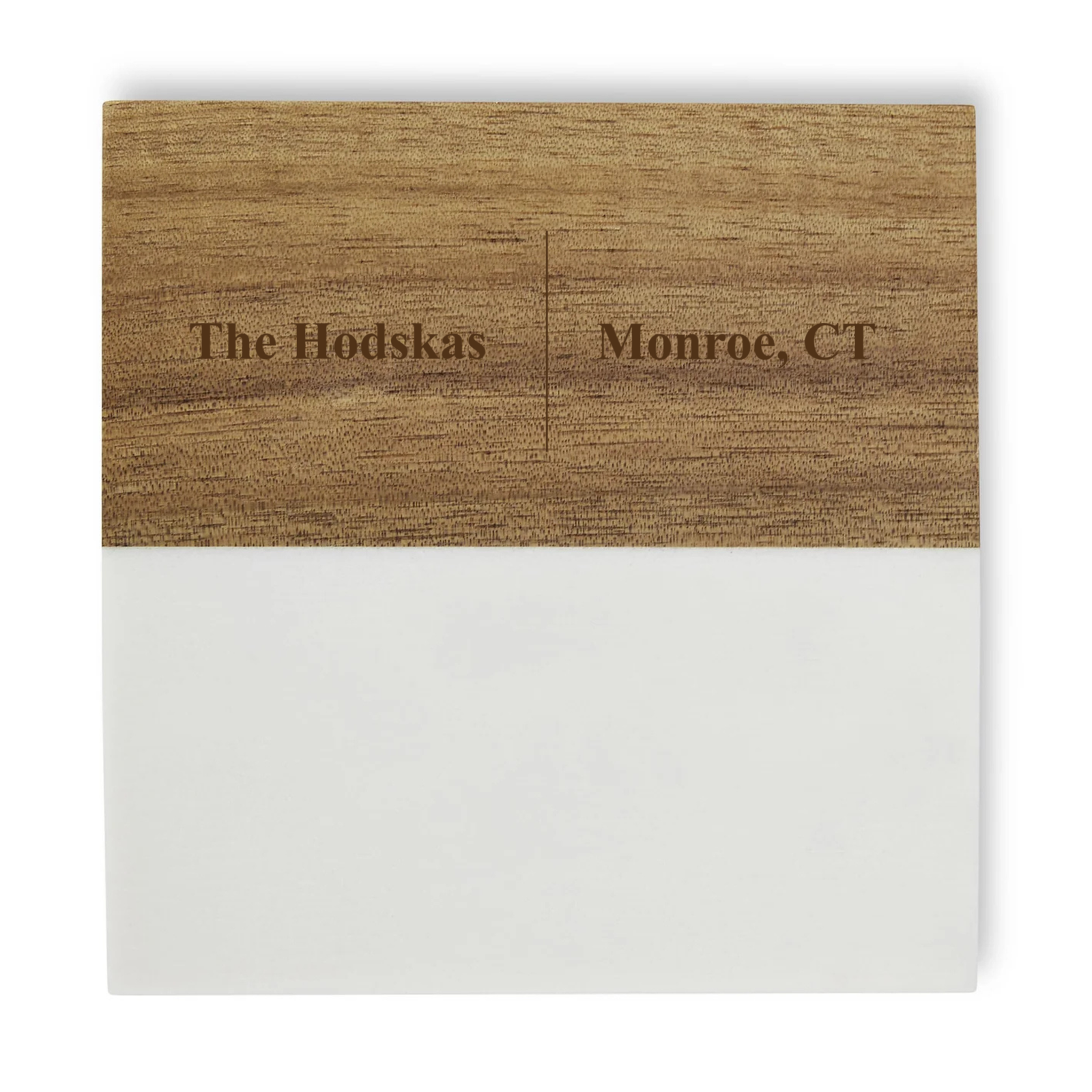 Wooden coaster with sample personalization reading "The Hodskas" and "Monroe, CT" engraved on natural wood surface with white base