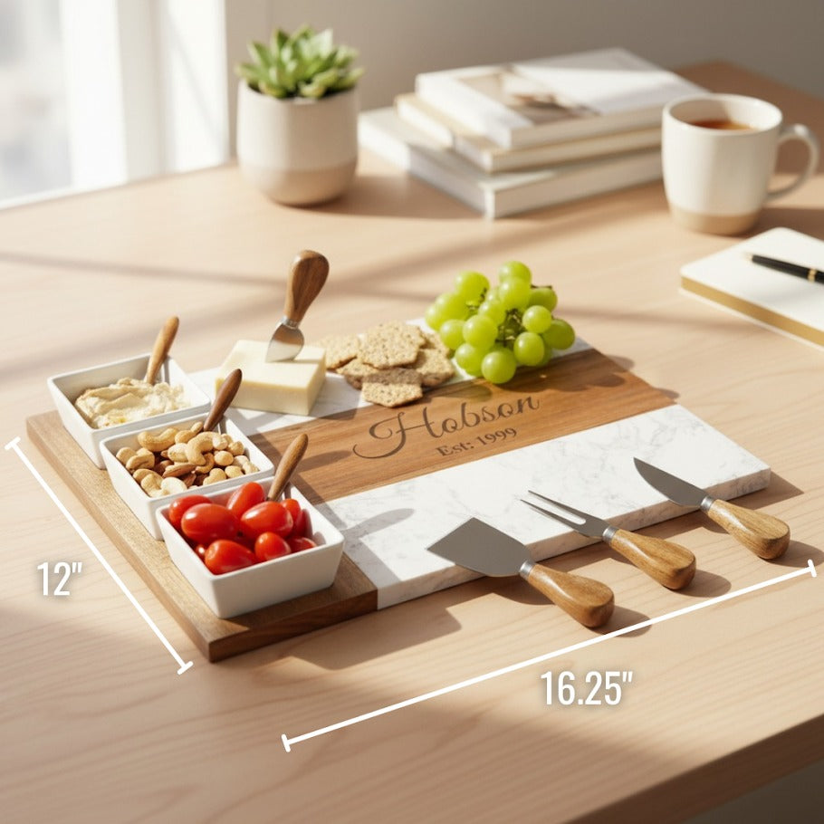 Personalized wooden charcuterie board with sample engraving "Habson" and date, styled with three white ceramic bowls, cheese, crackers, grapes, and wooden spreaders.