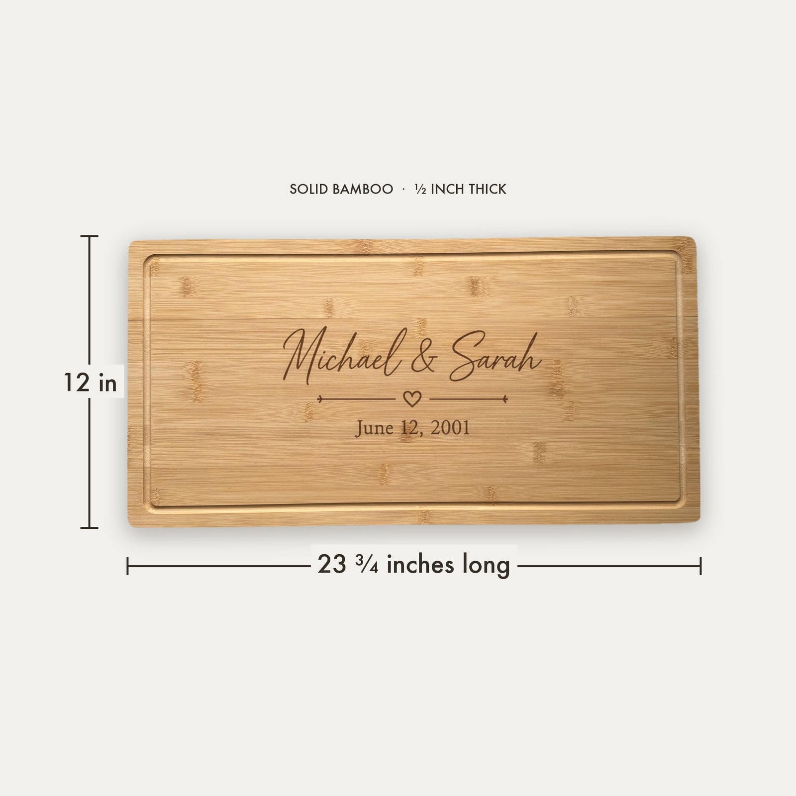 Size guide for the personalized wedding serving board: solid bamboo, 23 3/4 inches long, 12 inches wide and 1/2 inch thick, engraved Michael & Sarah