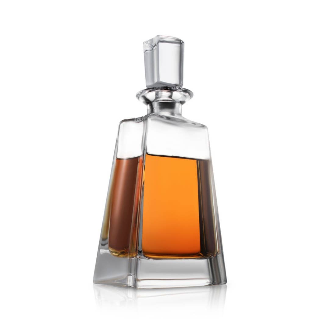 Crystal decanter filled with amber whiskey, featuring a tapered square body, wide base, and glass stopper with rectangular cap.