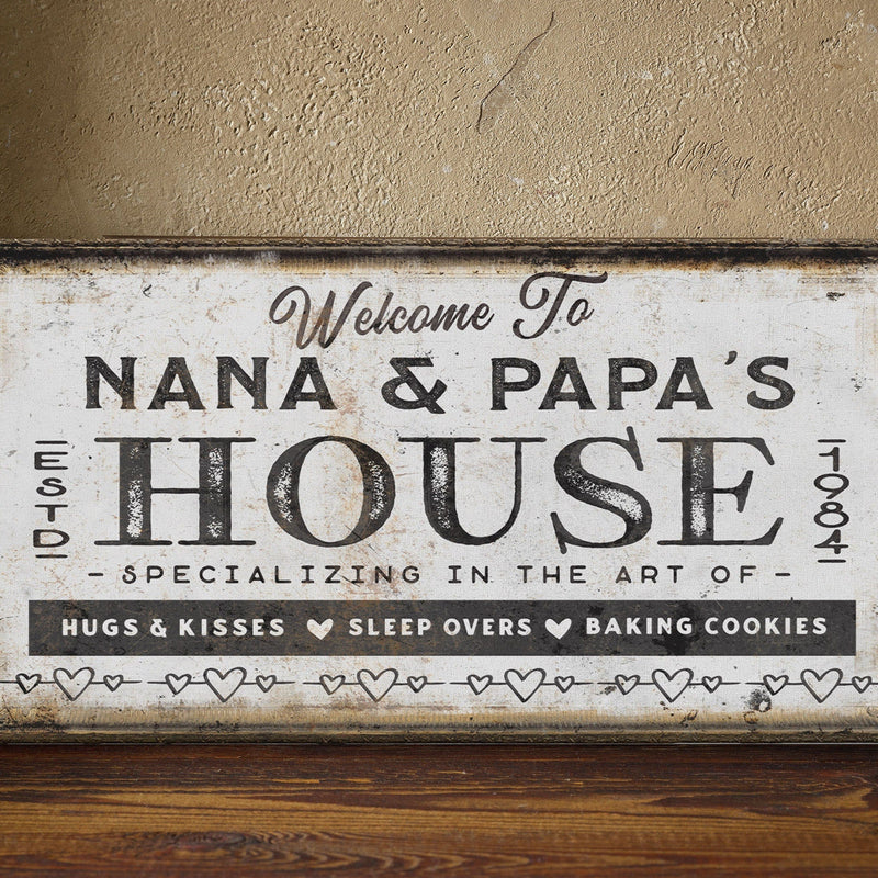 Personalized canvas sign with sample text "Welcome To Nana & Papa's House Est. 1984" in distressed cream and black finish with rustic frame.