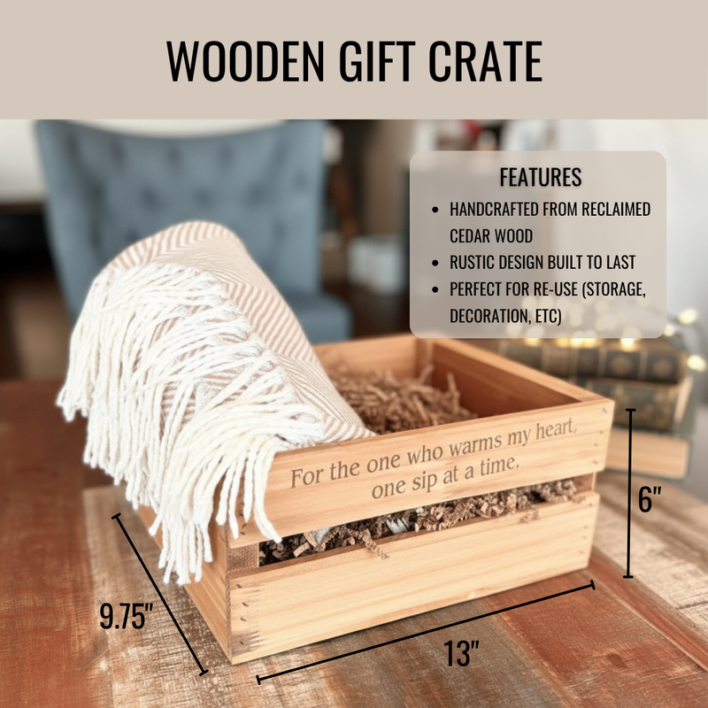 Wooden gift crate with laser-engraved text reading "For the one who warms my heart, one sip at a time," filled with cream tassel throw blanket and natural wood items, measuring 13 inches wide by 9.75 inches deep by 6 inches tall.