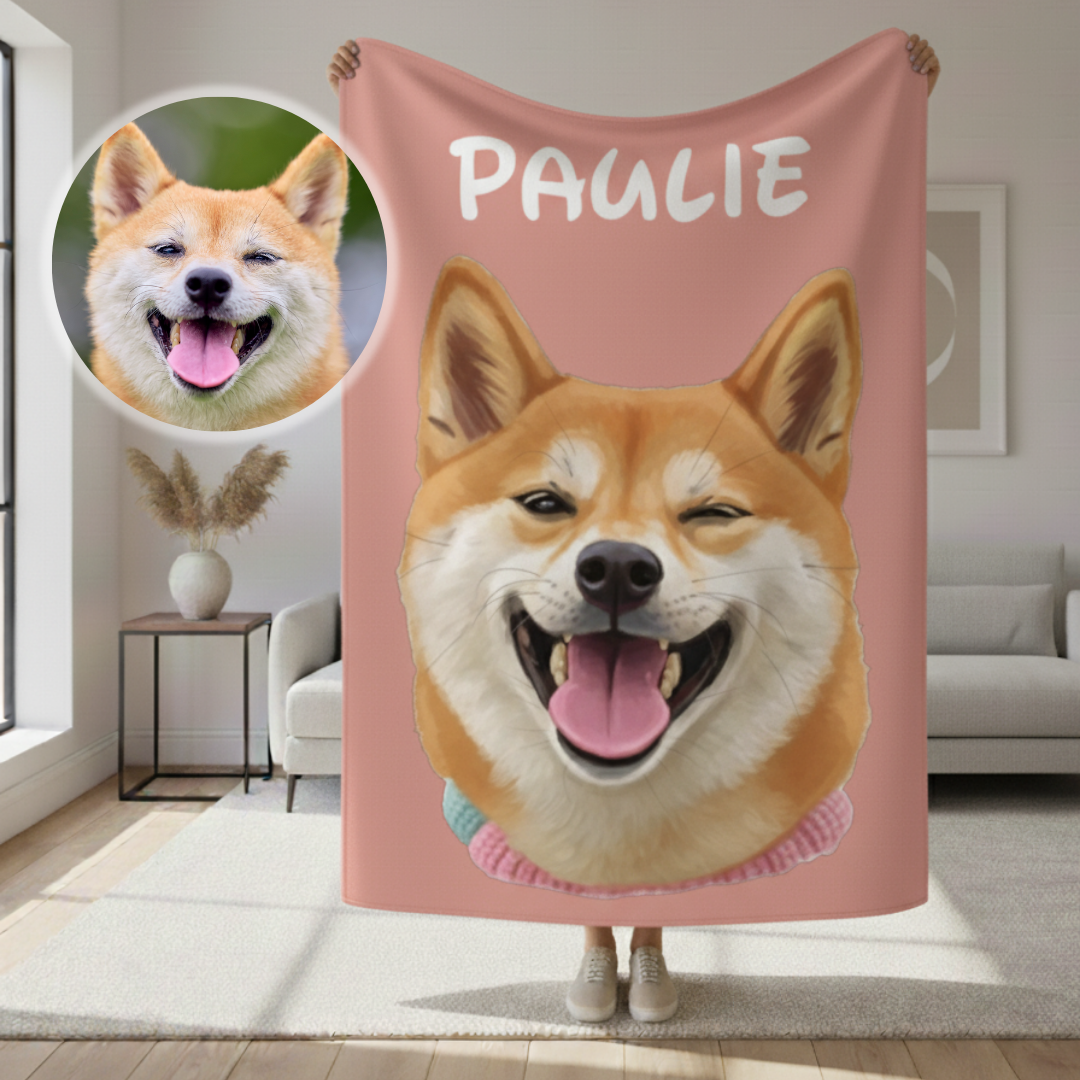 Rose pink sherpa blanket featuring a cartoon portrait of a smiling tan and white dog with sample name "PAULIE" printed above, displayed held up indoors with a photo reference circular inset showing the original dog photo.