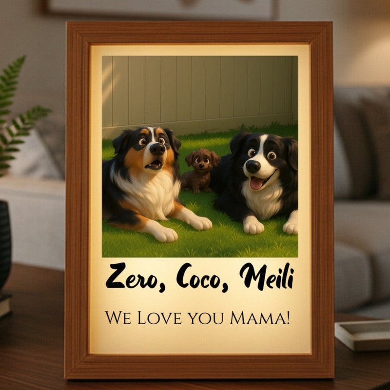 Framed animated portrait showing three stylized dogs on grass with sample names "Zero, Coco, Meili" and text "We Love You Mama" on warm cream mat with wooden frame