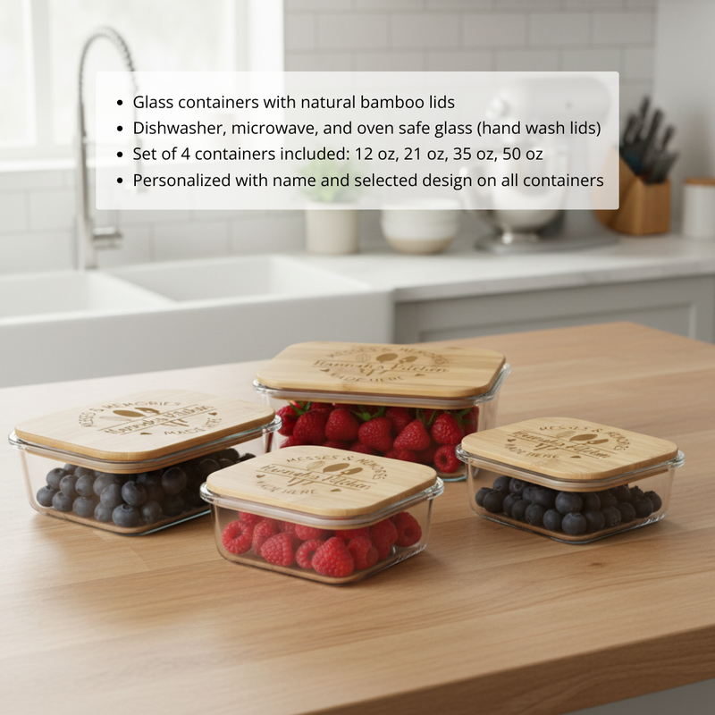 Four glass storage containers in graduated sizes filled with raspberries and blueberries, each with a bamboo lid laser-engraved with a sample name and decorative design, arranged on a wooden countertop.