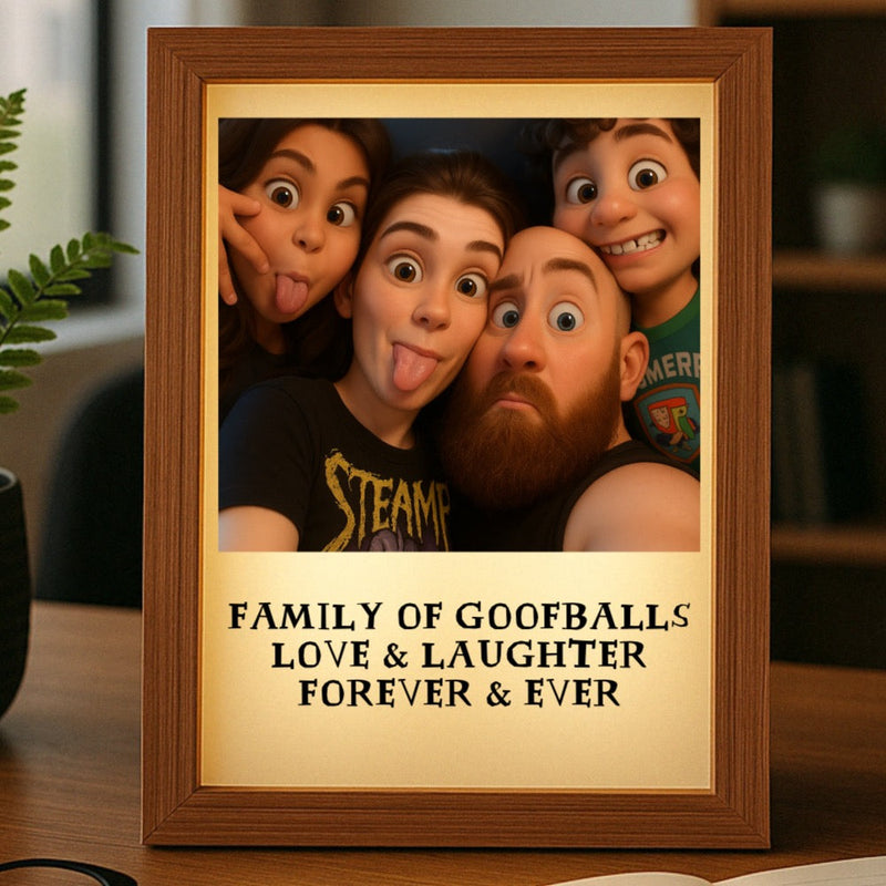 Wood-framed light box displaying a cartoon-style family portrait with text reading "Family of Goofballs Love & Laughter Forever & Ever" on cream mat below the image