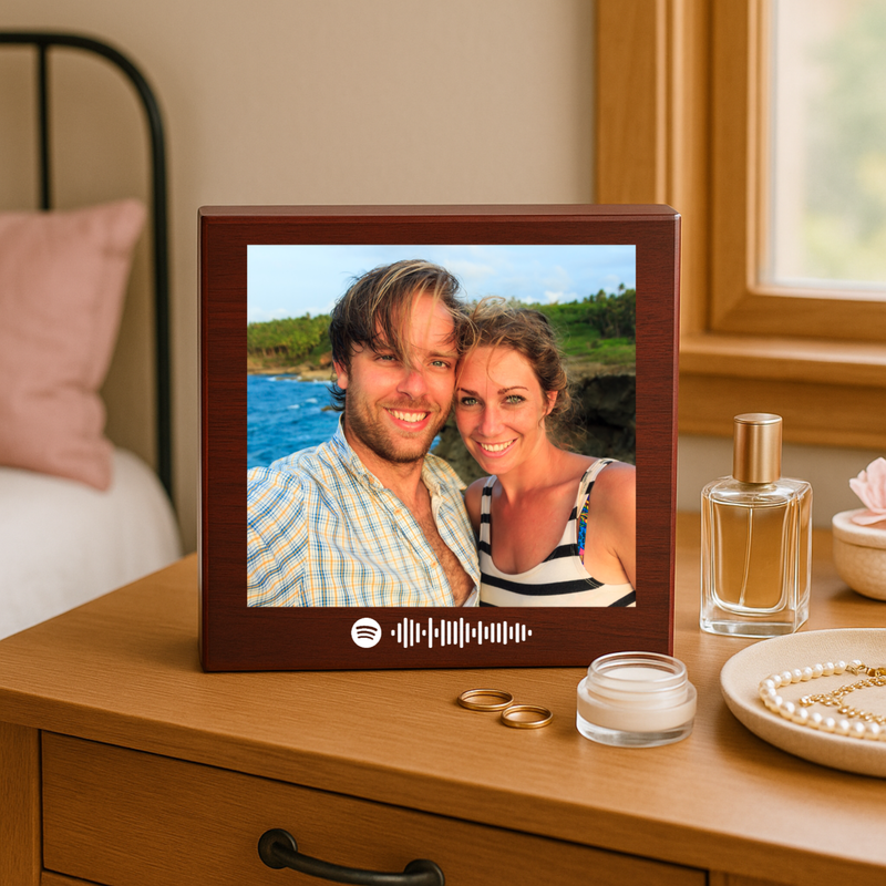 Dark cherry wood keepsake box displayed on wooden dresser, showing photo of couple at beach with white Spotify code scannable graphic below the image