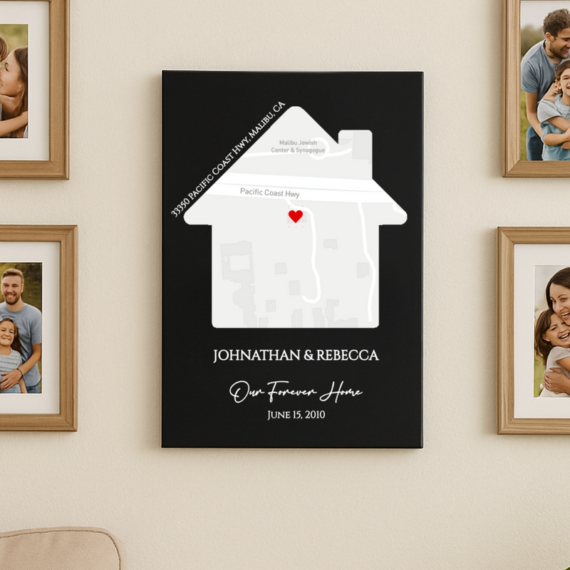 Black canvas with white house-shaped map showing sample address and red heart marker, personalized with names "JOHNATHAN & REBECCA" and date "JUNE 15, 2010" with "Our Forever Home" text