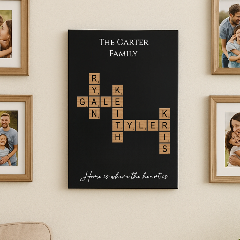 Black wall art with sample family names "Carter," "Gale," "Ryan," "Kyle," "Tyler," and "Khs" arranged in crossword pattern with wood-grain letter tiles and italic script reading "Home is where the heart is