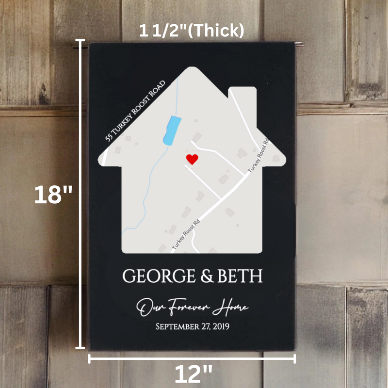 Black house-shaped sign with sample map showing "$5 Turkey Roost Road" and "Turkey Roost Rd" with red heart marker, customized with names "GEORGE & BETH," text "Our Forever Home," and date "SEPTEMBER 27, 2019