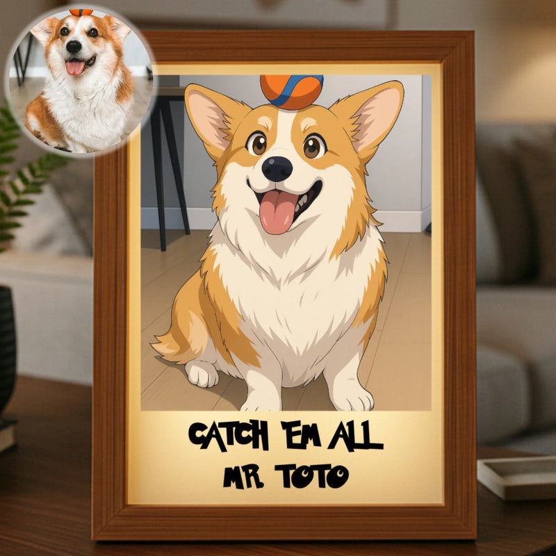 Framed anime-style portrait of a smiling corgi with sample personalization reading "CATCH 'EM ALL MR TOTO" on the mat, displayed on a wooden desk with plant in background