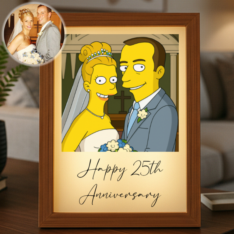 Framed cartoon illustration showing a bride and groom in yellow with "Happy 25th Anniversary" text, displayed on a wooden shelf with a sample photo inset in upper corner.