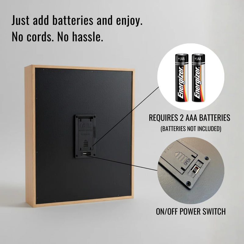 Back panel of wood-framed light showing battery compartment with two AAA battery slots and on/off power switch, instructional callout text indicating battery requirements