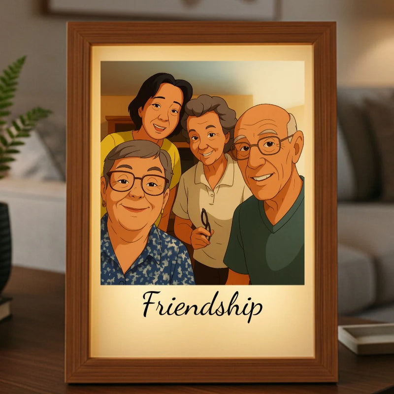 Framed cartoon portrait featuring four smiling people with "Friendship" text below, displayed on a wooden shelf with warm LED backlighting