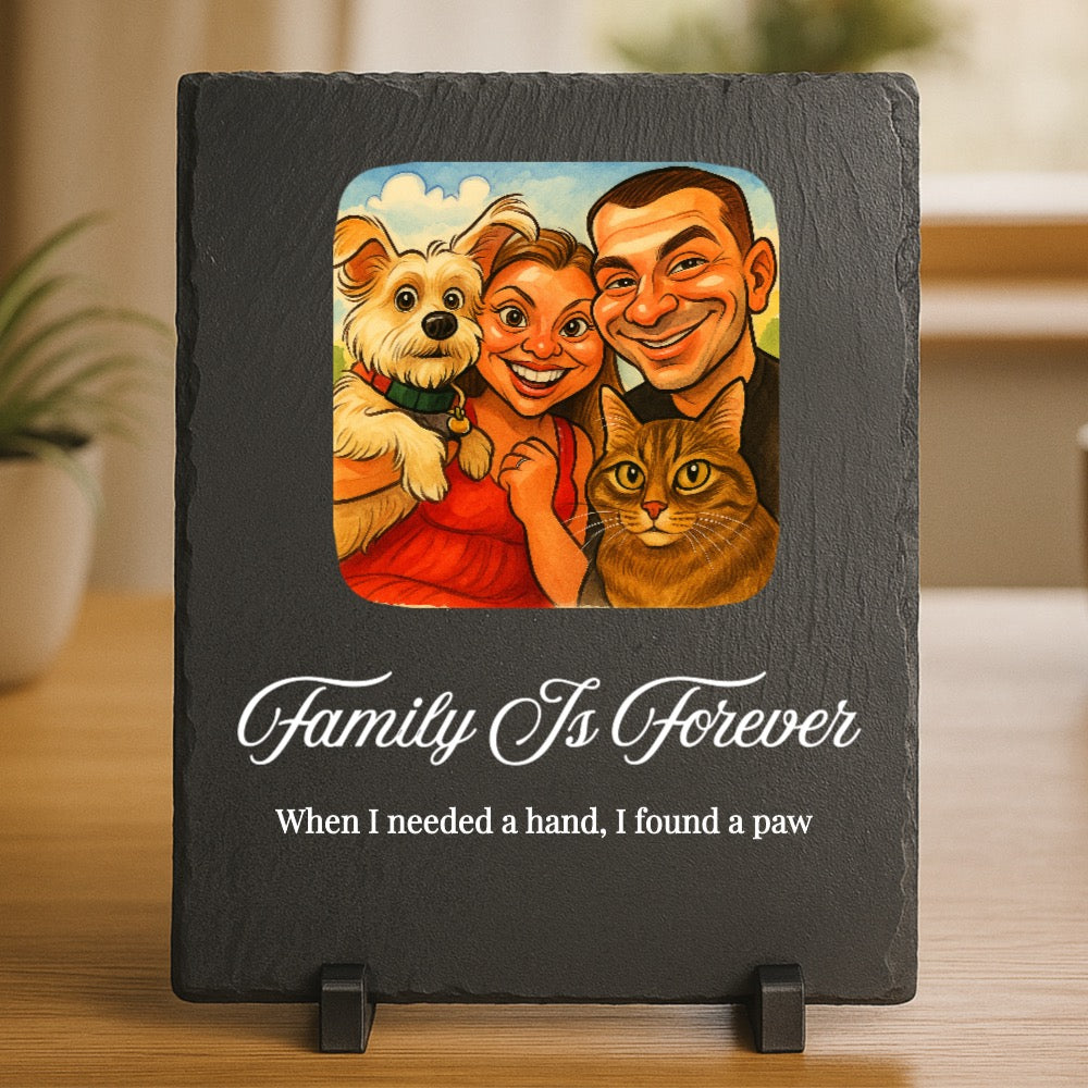 Black slate plaque with caricature illustration of two people and two pets, engraved with "Family Is Forever" and "When I needed a hand, I found a paw