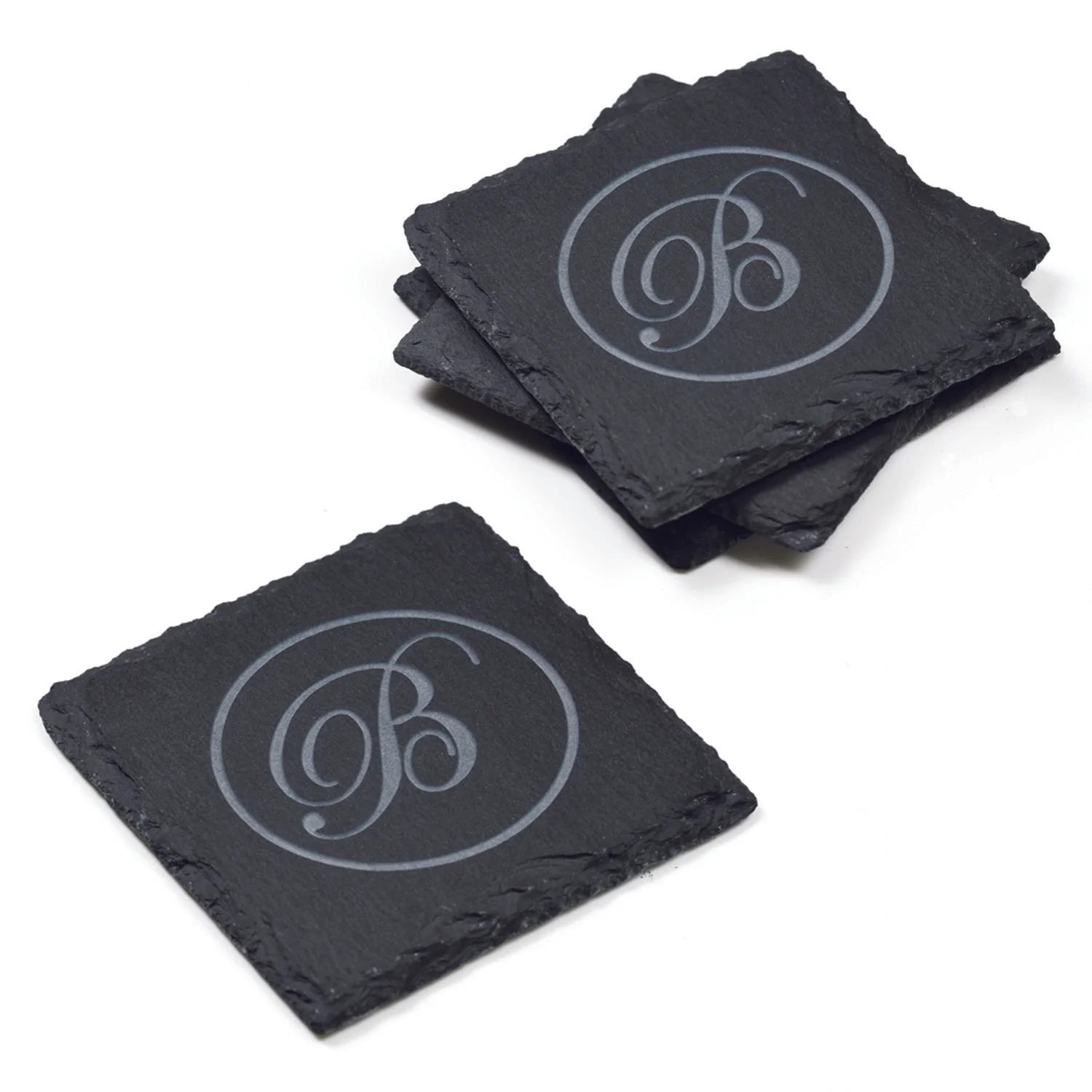 Square Natural Slate Coasters with engraved script monogram on wood table