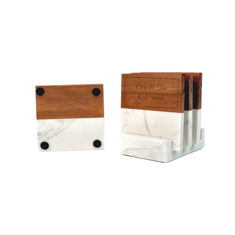 Wooden and marble coaster set with sample personalization reading Clara & Tom, Est. 1999, shown as individual coaster and in matching holder with black feet