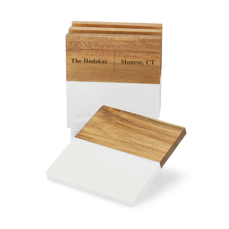Wooden coaster set with sample personalization reading "The Hodskas" and "Monroe, CT" engraved on top surface, shown with one coaster displayed separately