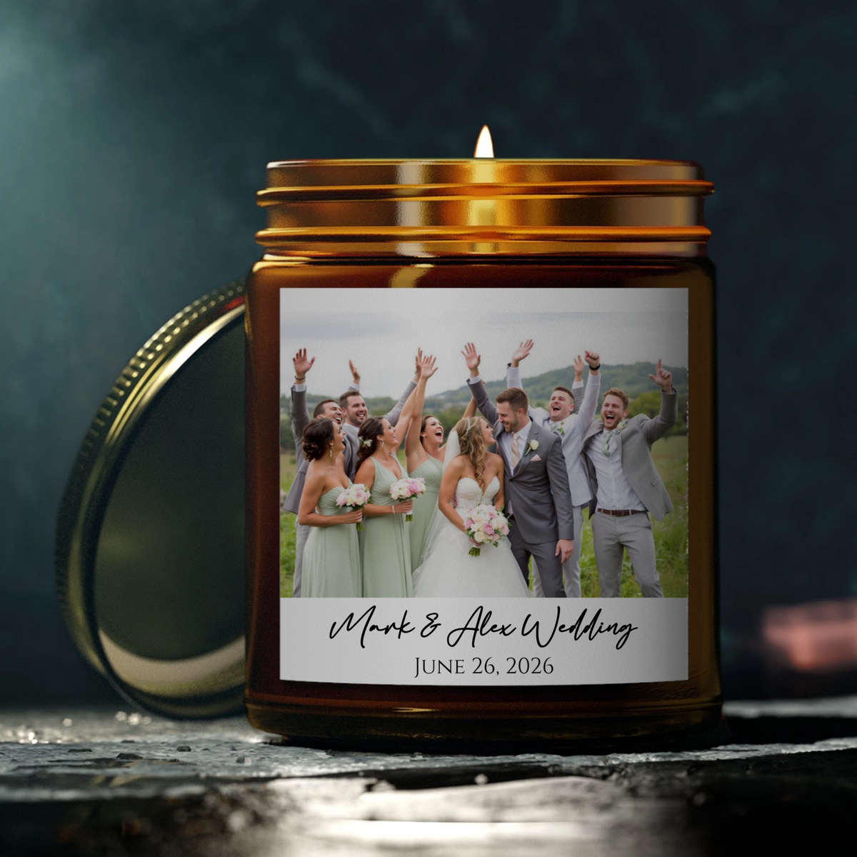 Amber glass keepsake candle with gold lid and handle, featuring sample wedding photo and personalized text reading "Mark &amp; Alex Wedding June 26, 2026