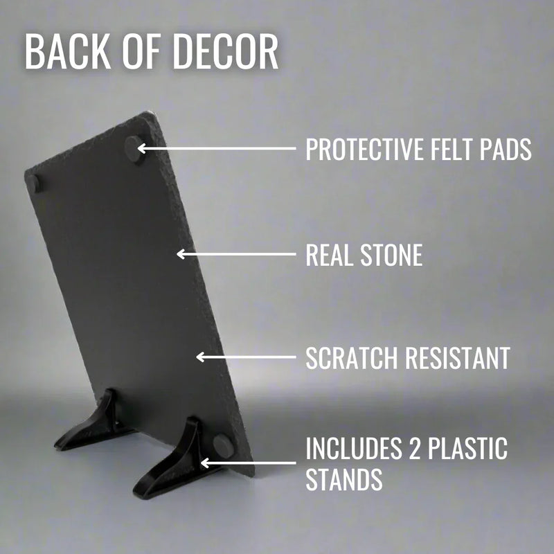 Back view of black slate plaque showing protective felt pads at top corners, real stone surface, scratch-resistant finish, and two black plastic display stands included at base