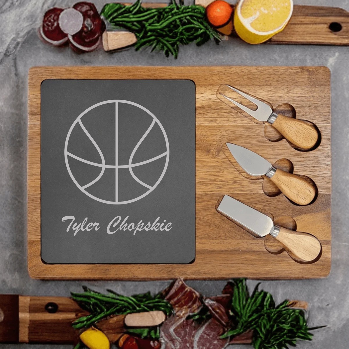 Personalized Basketball Charcuterie Board engraved with a basketball and a custom name on a slate and acacia wood board with cheese knives