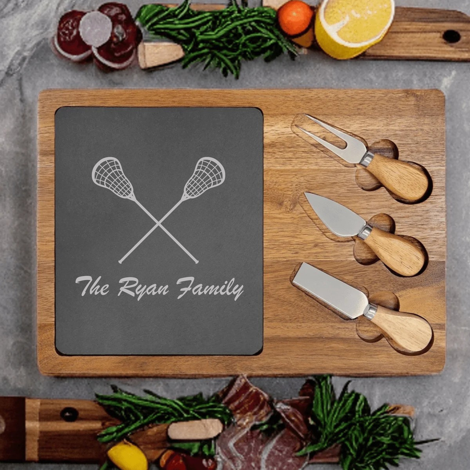 Personalized Lacrosse Charcuterie Board engraved with crossed lacrosse sticks and a custom name on a slate and acacia wood board with cheese knives