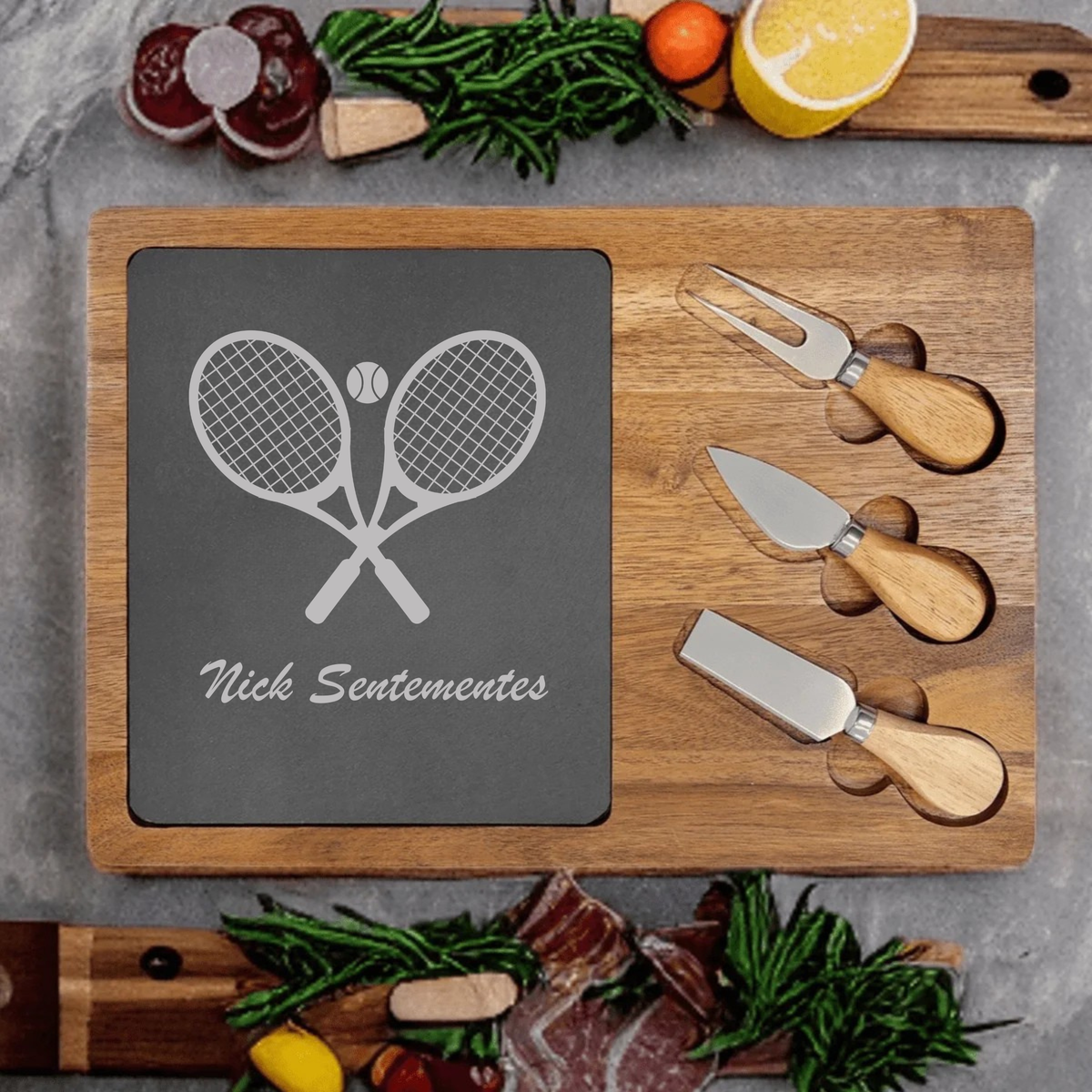 Personalized Tennis Charcuterie Board engraved with crossed rackets, a tennis ball, and a custom name on a slate and acacia wood board with cheese knives