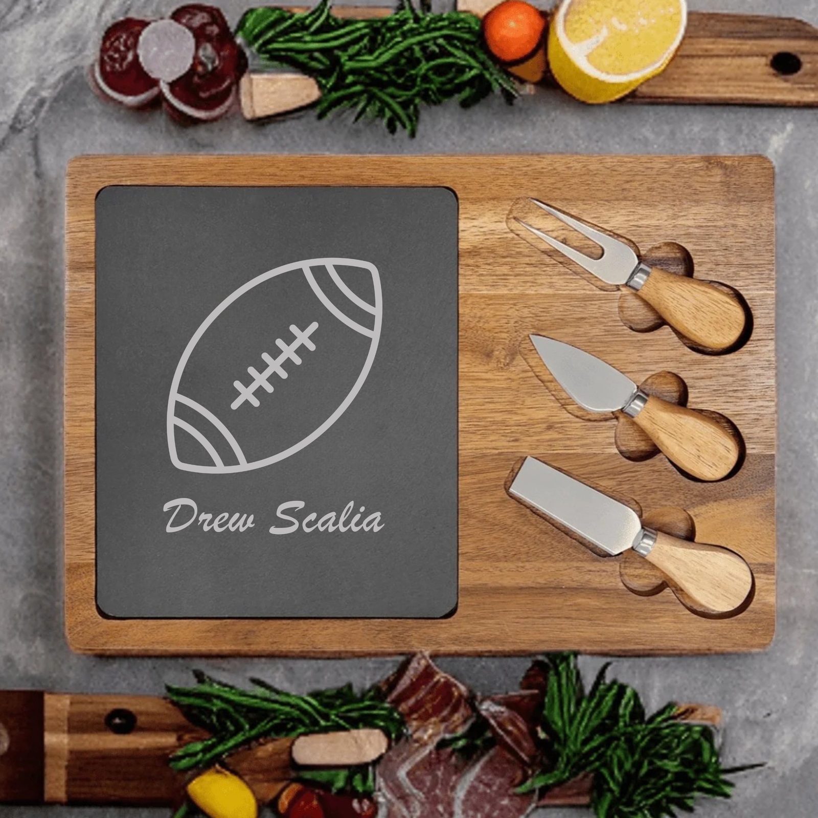 Personalized Football Charcuterie Board engraved with a football and a custom name on a slate and acacia wood board with cheese knives