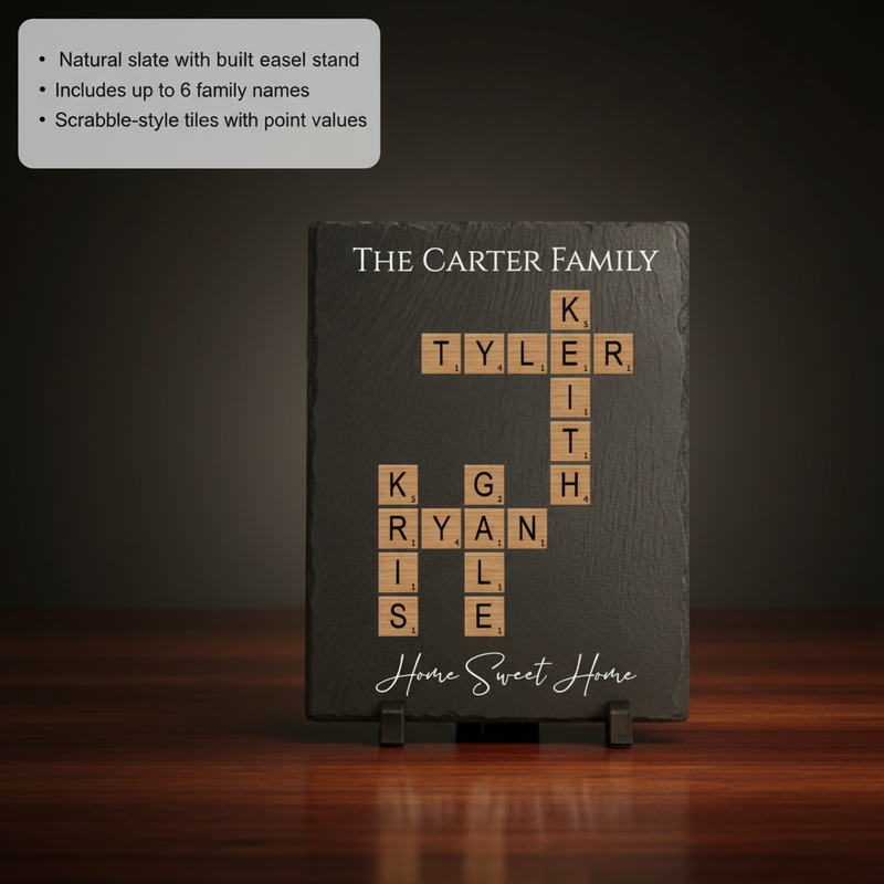 Natural slate board personalized with sample family names "Carter," "Tyler," "Keith," "Ryan," and others arranged in Scrabble-style crossword pattern with wooden letter tiles and point values, set on easel stand