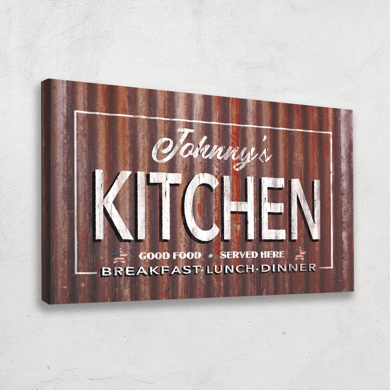 Personalized canvas sign with sample name "Johnny's" above "Kitchen" in script, white lettering on distressed rust-textured background, with "Good Food Served Here" and "Breakfast Lunch Dinner" text below