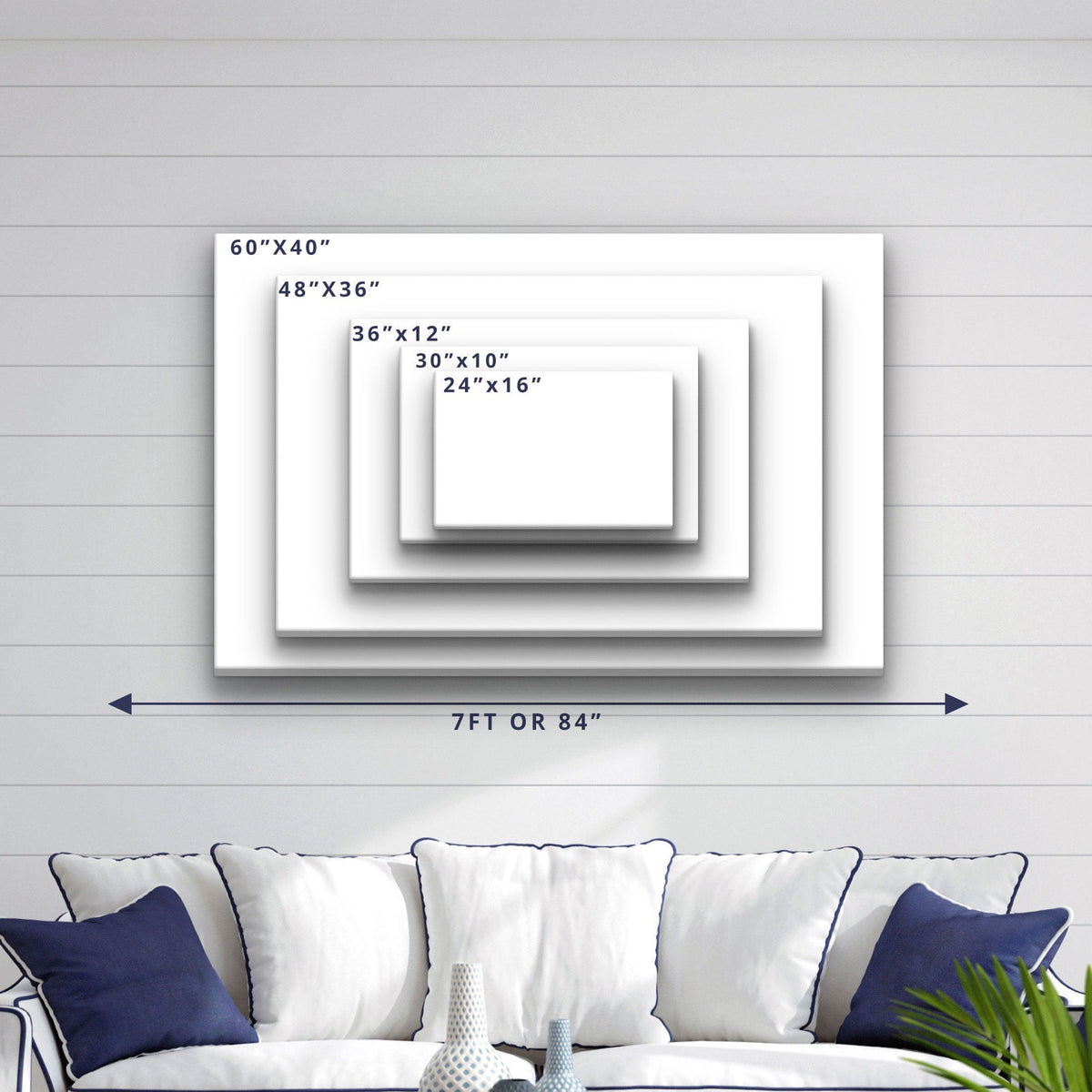 Size comparison chart showing five canvas dimensions from 24"x16" to 60"x40", displayed on shiplap wall above a navy and white upholstered sofa