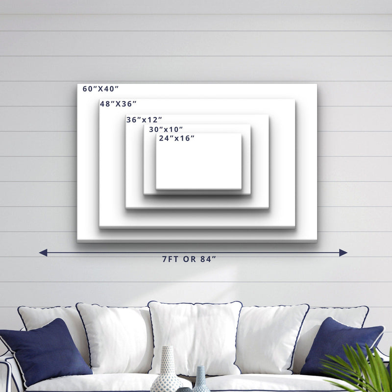 Size comparison chart showing five canvas dimensions from 24"x16" to 60"x40", displayed on shiplap wall above a navy and white upholstered sofa