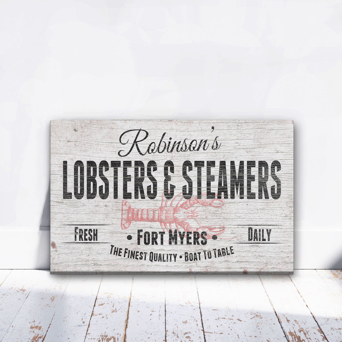 Personalized canvas sign with sample name "Robinson's" at top, "Lobsters &amp; Steamers" in large letters, red lobster illustration, and "Fort Myers" location text on distressed white wood background