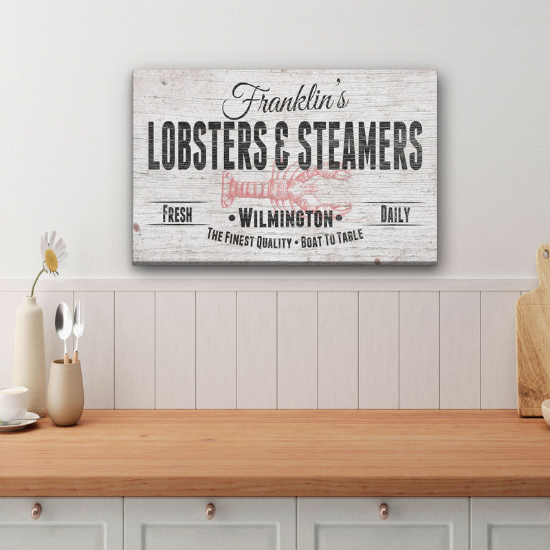 Personalized canvas sign with sample name "Franklin's" and location "Wilmington" displayed on kitchen wall above wooden counter with white shiplap backsplash