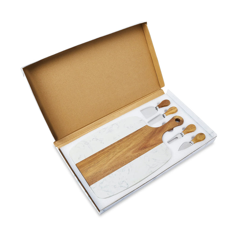 Open kraft box revealing marble and wood serving board with acacia wood handles, four small cheese knives with wooden handles, and white marble base plate inside.