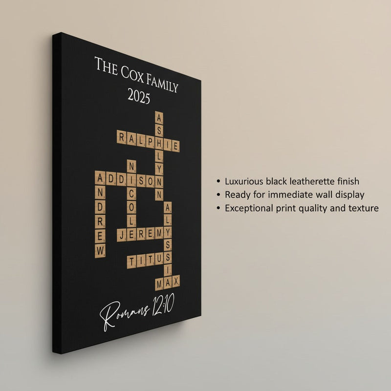 Black leatherette wall art with personalized crossword layout featuring sample family names "The Cox Family 2025" and "Romans 12:10" scripture reference in tan tile letters