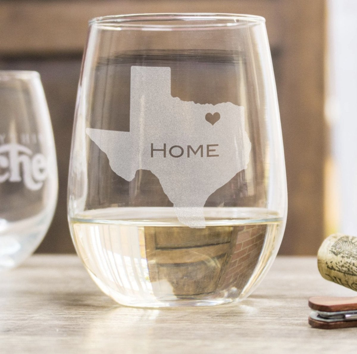 Stemless wine glass engraved with home state outline and heart hometown marker