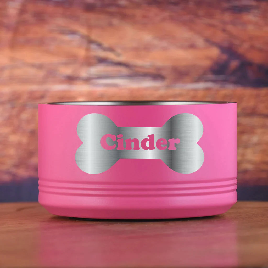 Pink pet bowl with bone-shaped cutout and sample name "Cinder" engraved in silver lettering on the side