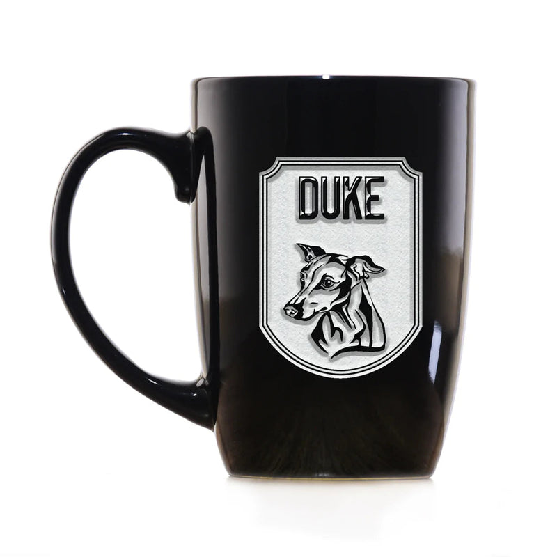 Black ceramic coffee mug with engraved shield design featuring dog breed portrait and sample name "DUKE