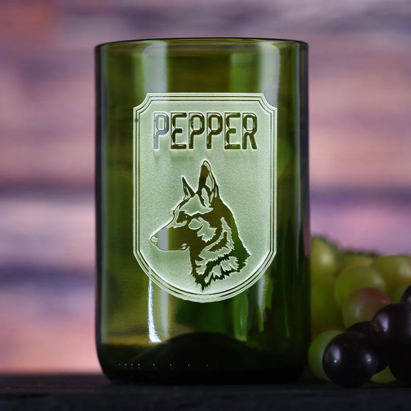 Green recycled wine bottle glass engraved with "PEPPER" text and German Shepherd dog head profile in a shield-shaped frame