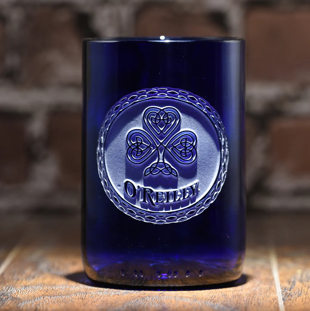 Deep blue recycled wine bottle glass with hand-carved Celtic clover and Claddagh design in circular frame, 4.5 inches tall.