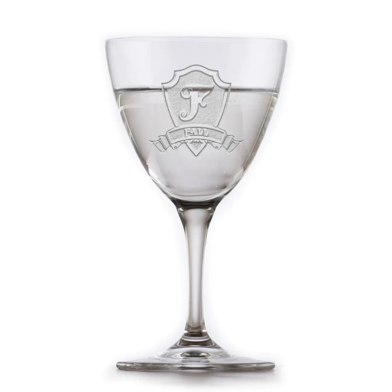 Crystal martini glass engraved with sample shield crest featuring monogram letter "F" and text "FAMILY" on the bowl