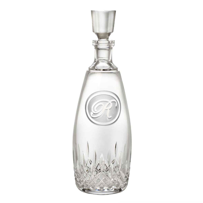 Clear crystal decanter with diamond-cut base and glass stopper, featuring a circular monogram with sample letter "R" engraved on front