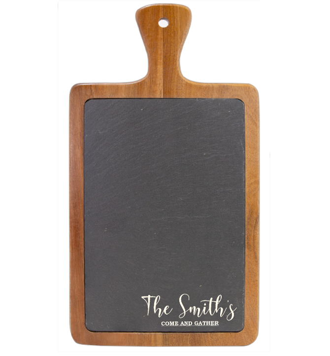 Acacia wood serving board with dark slate inlay, engraved with sample text "The Smith's" and "COME AND GATHER" in white script lettering