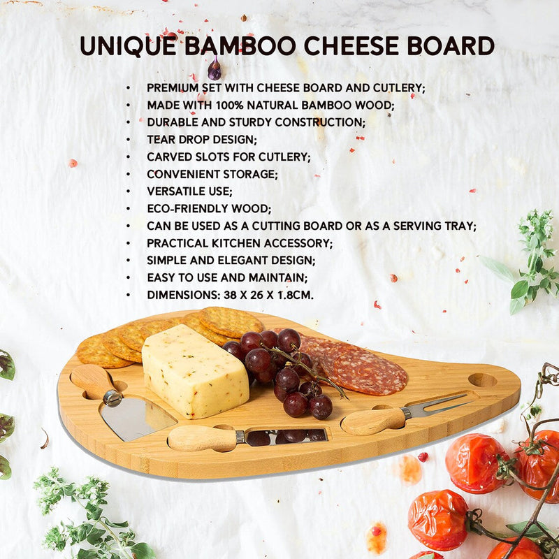 Teardrop-shaped bamboo cheese board with carved slots for knives, displayed with cheese, cured meat, grapes, and wooden serving utensils